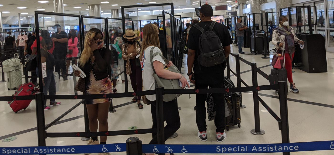Image: Travelers waiting in an airport security line (photo by Eric Bowman)