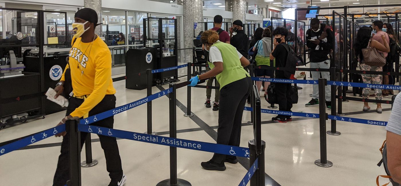 Image: Travelers waiting in the security line at the airport (photo by Eric Bowman)