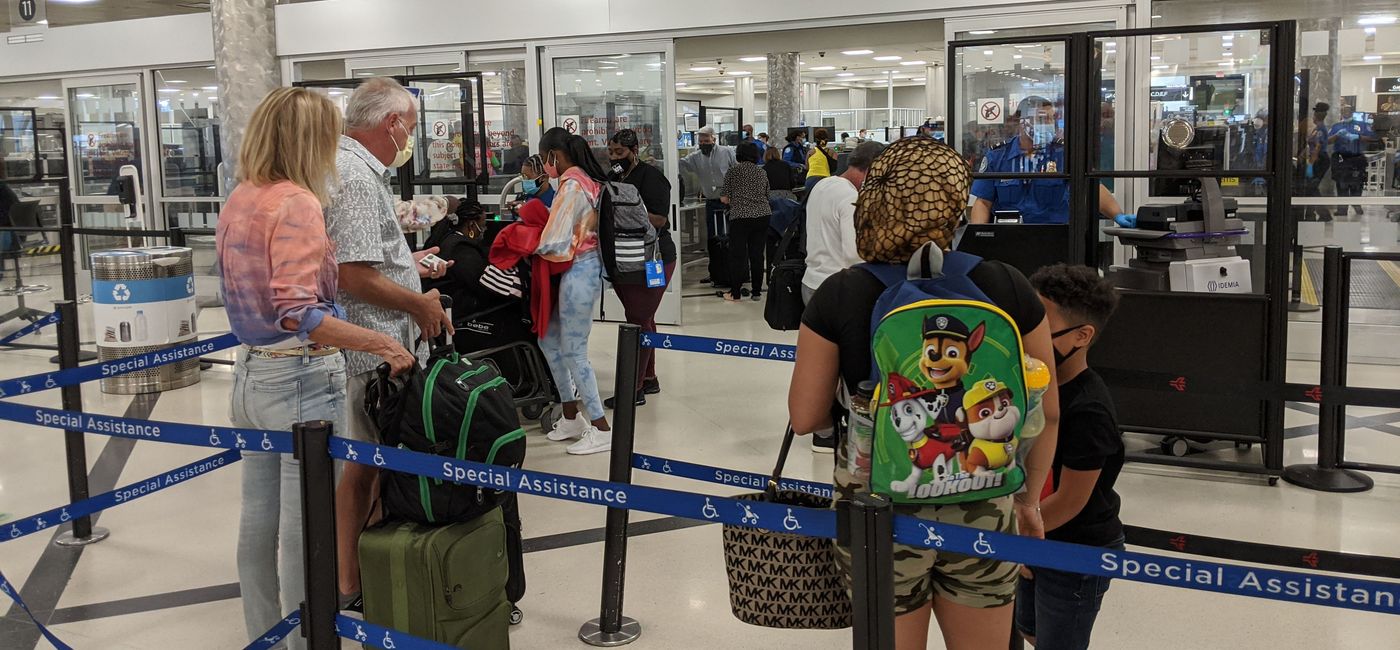 Image: PHOTO: Travelers wait in the security line at the airport. (Photo by Eric Bowman)
