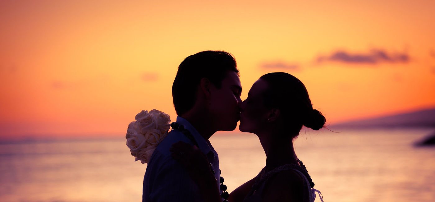 Image: Just-married couple on the beach. (Photo via iStock/Getty Images Plus/kieferpix)