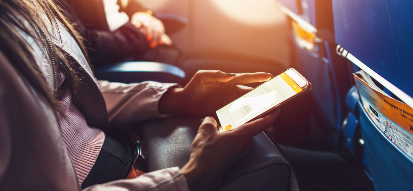 Image: Smartphone on an airplane  (photo via undrey / iStock / Getty Images Plus)