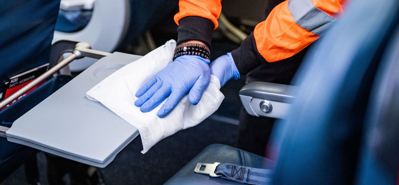 Image: PHOTO: A Delta Air Lines employee wipes down a tray table on one of its planes. (photo courtesy of Delta Air Lines) (Courtesy Delta Air Lines)