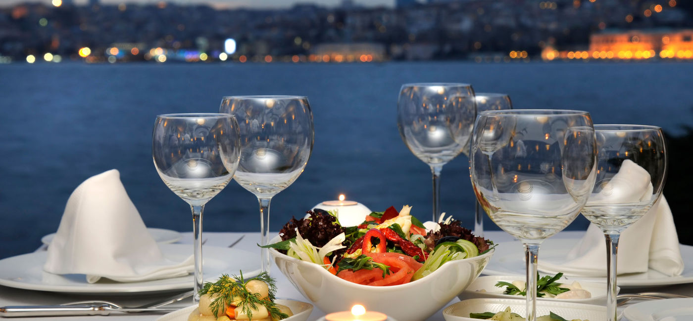 Image: PHOTO: Elegant dining with a stunning water view.. (Photo via iStock / Getty Images Plus / Czgur)