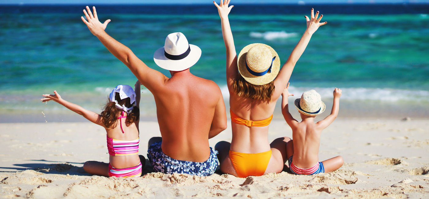 Image: A family vacationing in a sunny beach destination. (Source: evgenyatamanenko/iStock/Getty Images Plus)