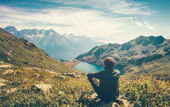 A Thinking Traveler Enjoys a Nice View of the Mountains