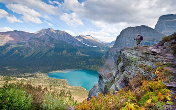 Hiker looking out from the Grinnell Glacier Trail in Glacier National Park