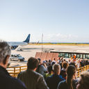 Tourists boarding a plane.