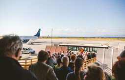 Tourists boarding a plane.
