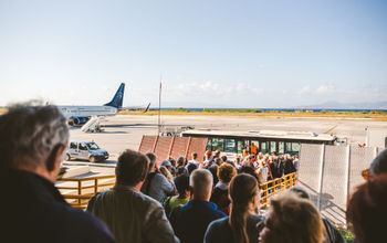 Tourists boarding a plane.