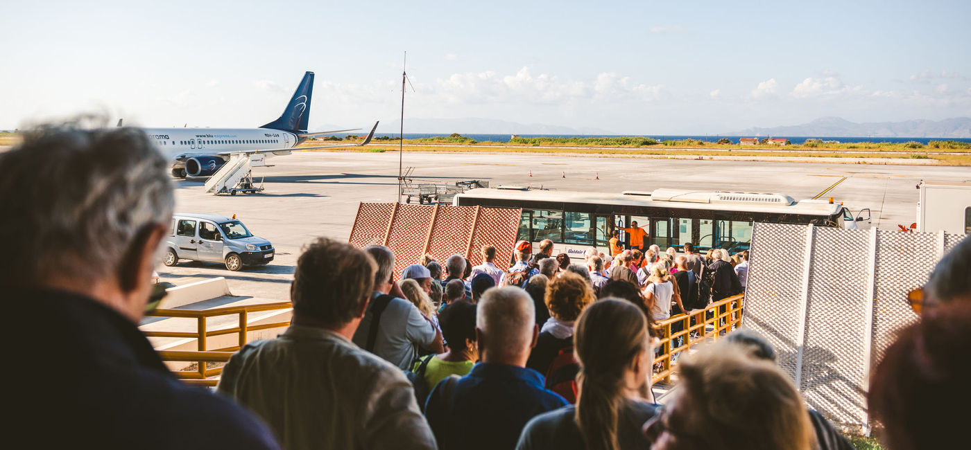 Image: Tourists boarding a plane. (photo via cunfek/iStock/Unreleased)