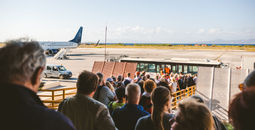 Tourists boarding a plane.