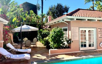 Bungalow exterior in pink with pool chairs and turquoise pool