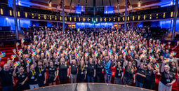 CoNexion attendees hold up their Nexion fans during a general session. 