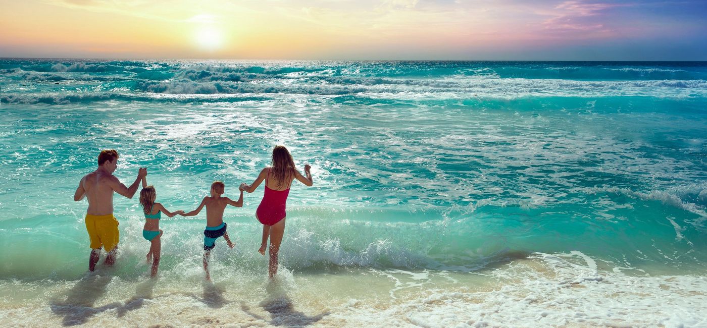Image: Family fun at the beach. (photo via Palace Resorts)