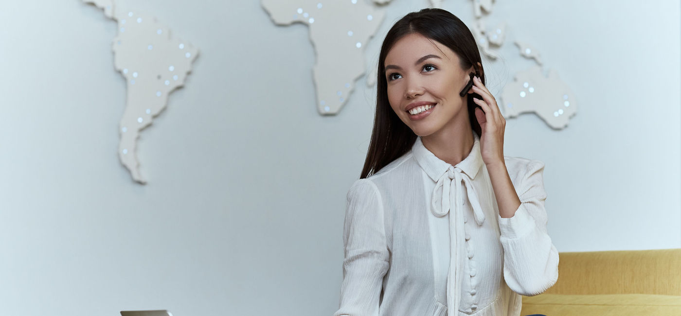 Image: Travel agent talking to a client over the phone. (photo via dima_sidelnikov/iStock/Getty Images Plus)