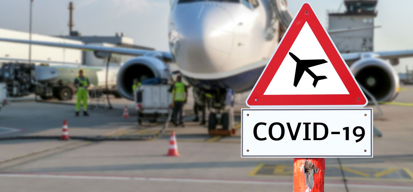 Image: PHOTO: Airplane with a coronavirus warning sign concept in the foreground. (Photo via iStock/Getty Images Plus/Animaflora)