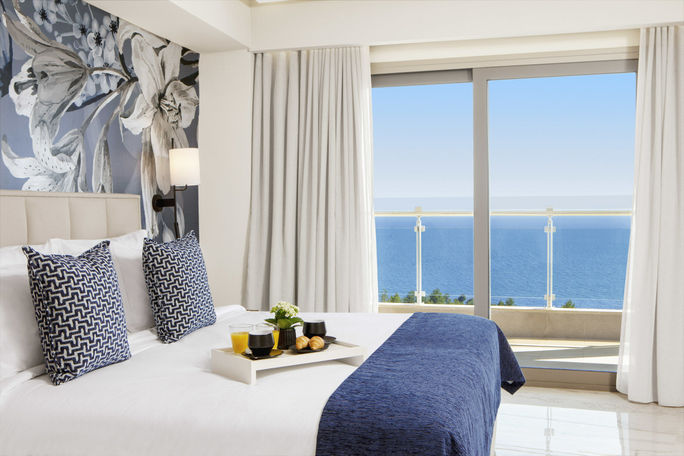 A guest room overlooking the Aegean Sea inside the new Ajul Luxury Hotel & Spa Resort, part of Wyndham's Registry Collection. Registry Collection, Wyndham hotels and resorts, Ajul Luxury hotel & spa resort, hotels in Halkidiki, resorts in Halkidiki