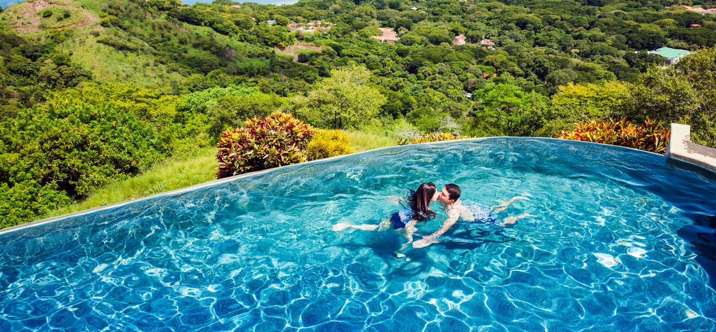 Photo: Couple enjoying an infinity pool in Costa Rica. (photo via Fertnig/E+)