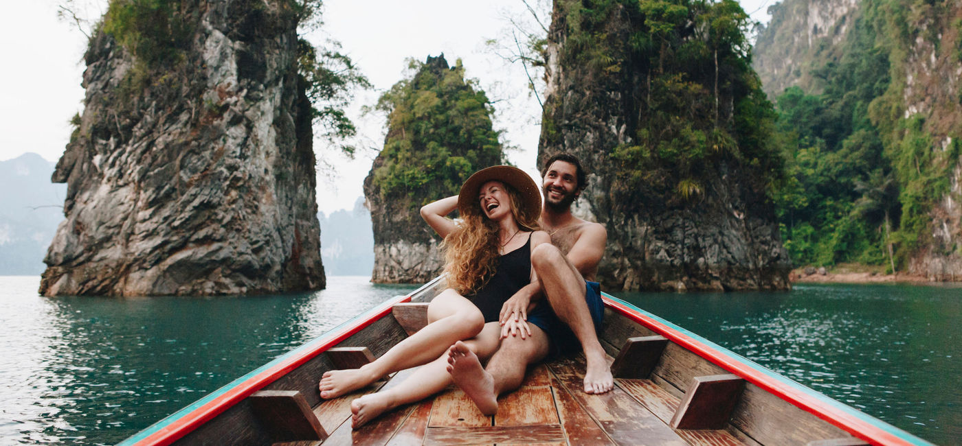 Photo: Couple relaxing on a boat in Thailand. (photo via Rawpixel/iStock/Getty Images Plus)