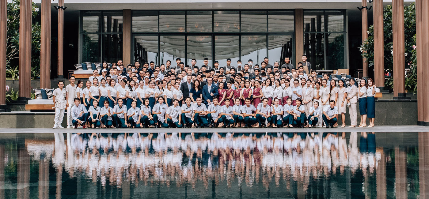 Image: The staff of Regent Phu Quoc pose outside of the new resort during its ribbon cutting ceremony. (photo via IHG Hotels & Resorts) ((photo via IHG Hotels & Resorts))