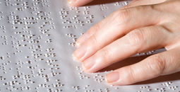 Hands on Braille text.