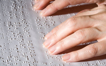 Hands on Braille text.