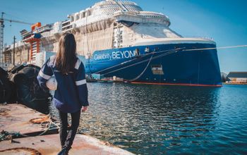 Captain Kate McCue, the first American female cruise ship captain, watches as construction continues on Celebrity Beyond at the Chantiers de l'Atlantique shipyard in Saint-Nazaire, France.
