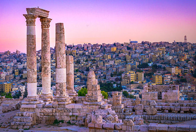 Sunset on Skyline of Amman and old town with a view over historic capital of Jordan