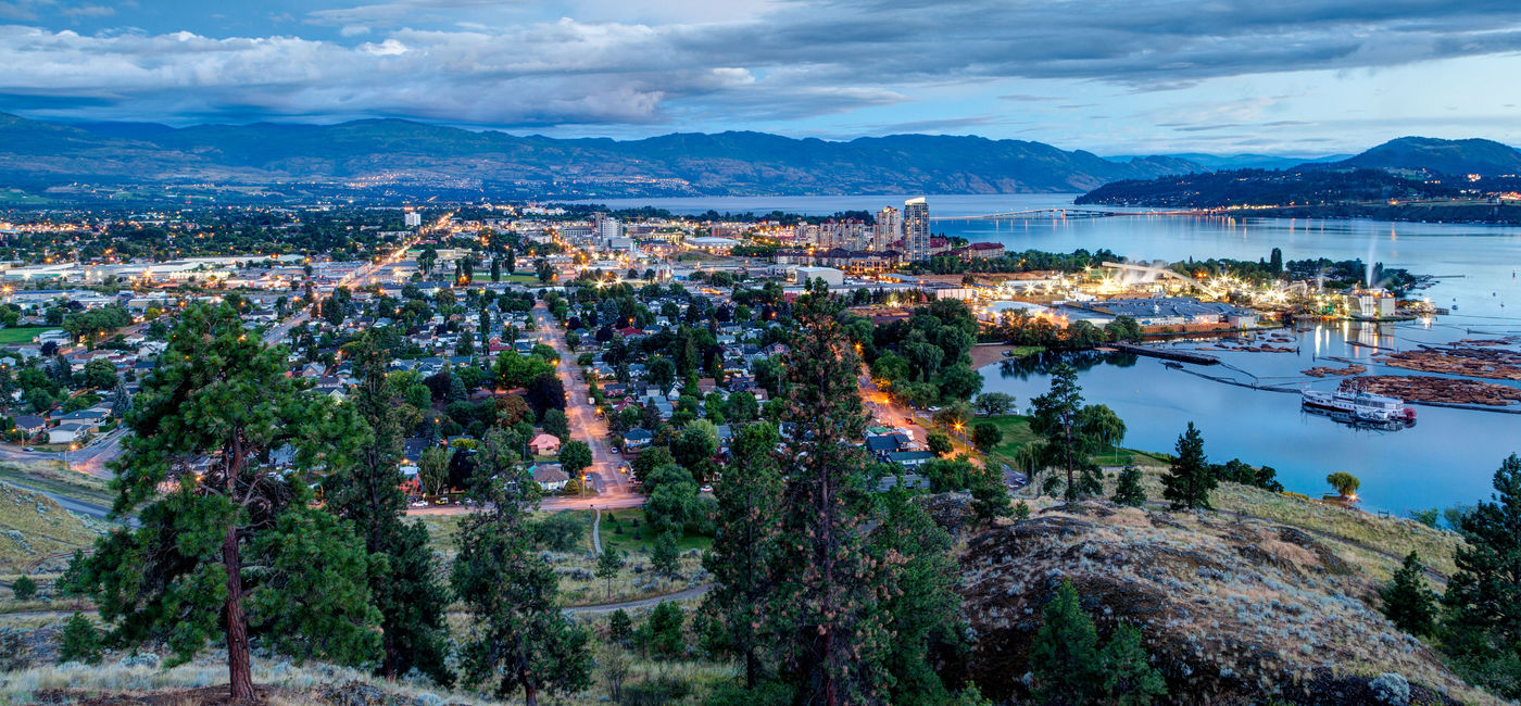 Image: Aerial View of Kelowna, British Columbia, just after sunset on Knox Mountain, Canada. (Photo via ronniechua / iStock / Getty Images Plus)