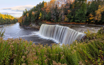 A panoramic view of the very picturesque Tahquamenon Falls and Tahquamenon River during Autumn, Upper Peninsula, Michigan, USA (photo via DougLemke / iStock / Getty Images Plus)