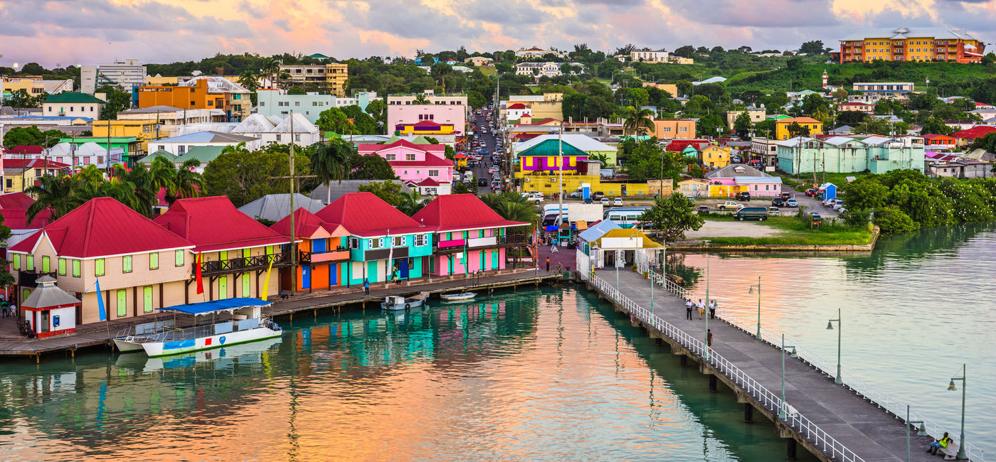 Image: PHOTO: St. John's, Antigua port and skyline at twilight. (Photo via Sean Pavone / iStock / Getty Images Plus)