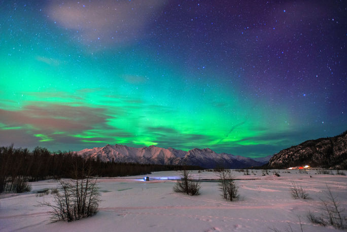 Aurora Borealis in Alaska Beautiful green Northern light (Aurora Borealis) at Knik River in Alaska. (Photo via CNaene / iStock / Getty Images Plus)