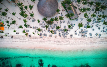 Aerial view of tropical island beach. Dominican Republic. (photo via valio84sl / iStock / Getty Images Plus)