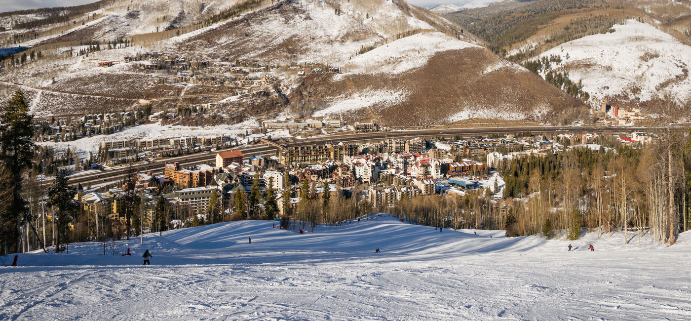 Image: View of Vail, Colorado and Interstate 70 from skiing slopes. (photo via miralex / iStock / Getty Images Plus)