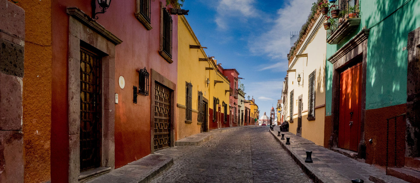 The many backstreets of San Miguel de Allende in Mexico can be quiet, colorful and beautifully preserved. A wonderful serene place for a morning or evening walk. (photo via thupton / iStock / Getty Images Plus)