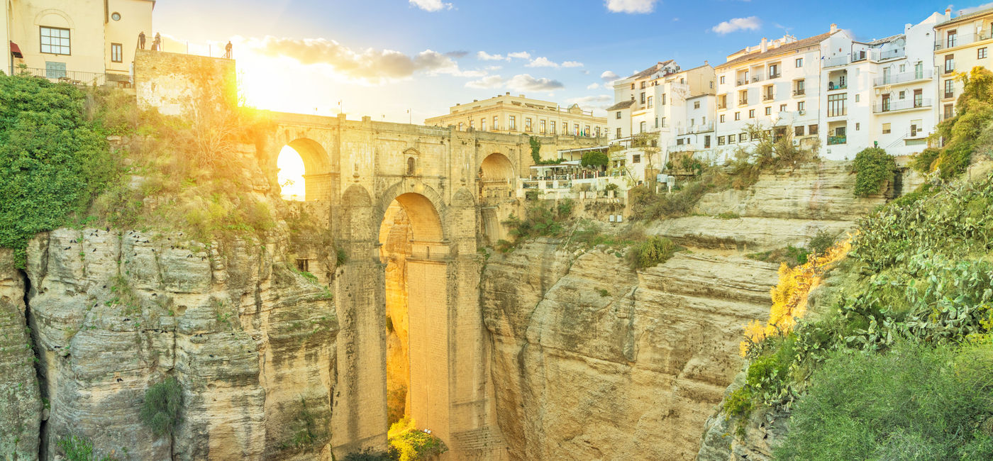 Image: Puente Nuevo bridge colored with light of setting sun, Ronda, Andalusia, Spain (photo via bbsferrari / iStock / Getty Images Plus)