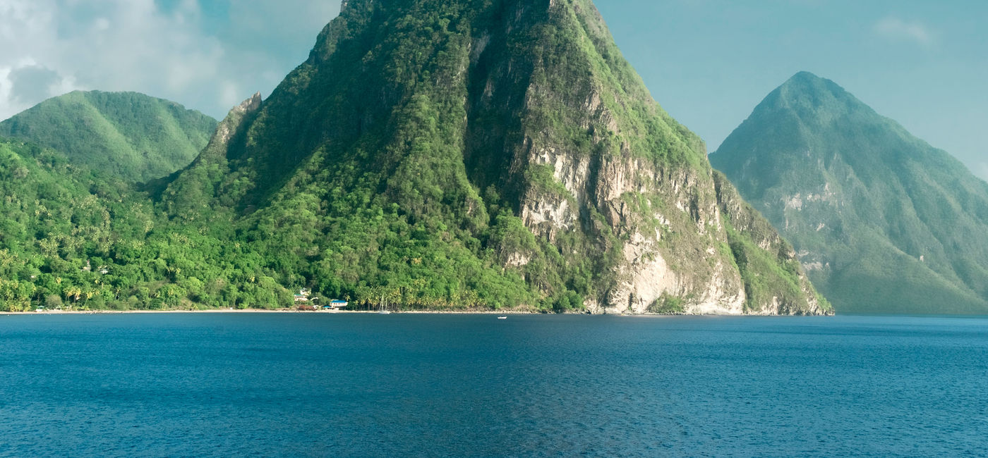 Image: A view of the famous Piton mountains in St Lucia. (photo via dani3315 / iStock / Getty Images Plus)