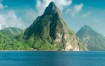 View of the famous Piton mountains in St Lucia (photo via dani3315 / iStock / Getty Images Plus)