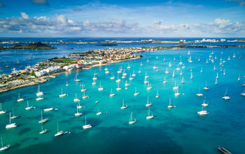 Morning light shines over the Marigot Bay in Saint Martin (photo via SpVVK / iStock / Getty Images Plus)
