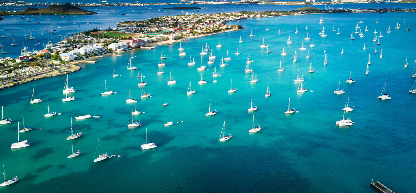 Image: PHOTO: Morning light shines over the Marigot Bay in Saint Martin (photo via SpVVK / iStock / Getty Images Plus)