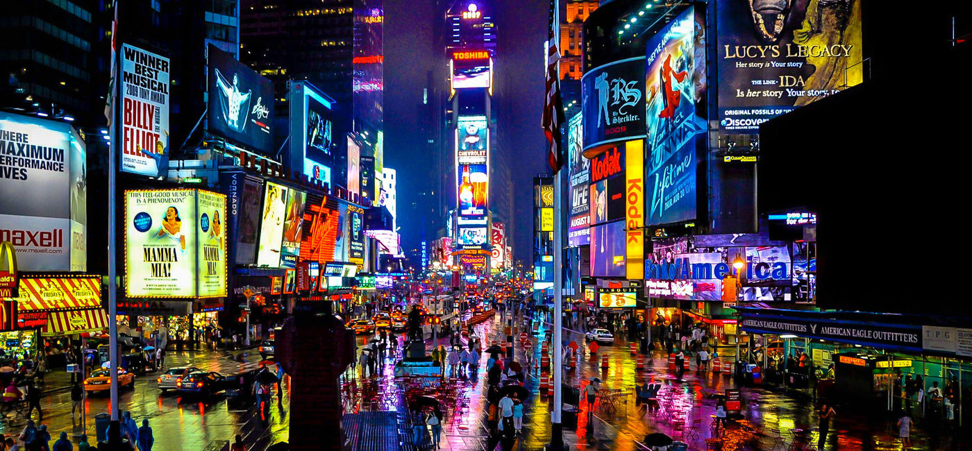 Image: PHOTO: Times Square in New York on a rainy night. (schalkm / iStock / Getty Images Plus)