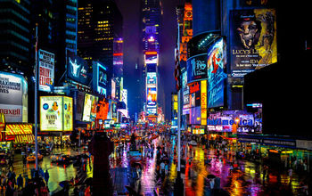 Times Square in New York on a rainy night. (schalkm / iStock / Getty Images Plus)