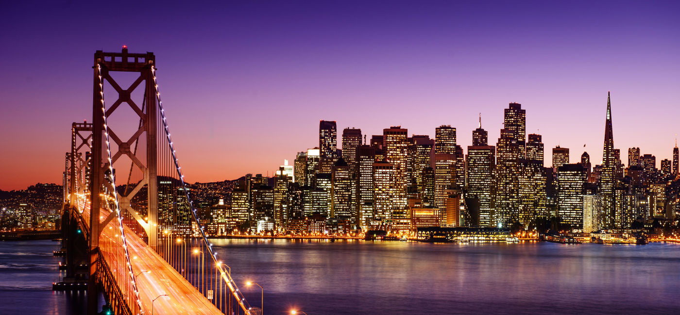 Image: San Francisco skyline and Bay Bridge at sunset, California (photo via dell640 / iStock / Getty Images Plus)