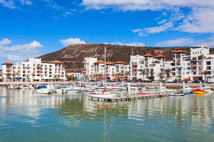 Agadir city, Morocco Boats at the Marina harbour in Agadir. Agadir is a major city in Morocco located on the shore of the Atlantic Ocean, near the Atlas Mountains. (photo via saiko3p/iStock/Getty Images Plus)