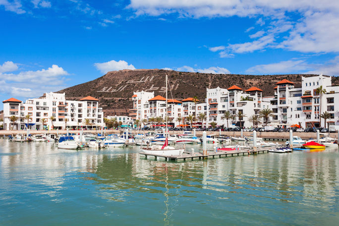 Boats at the Marina harbour in Agadir. Agadir is a major city in Morocco located on the shore of the Atlantic Ocean, near the Atlas Mountains. (photo via saiko3p/iStock/Getty Images Plus)