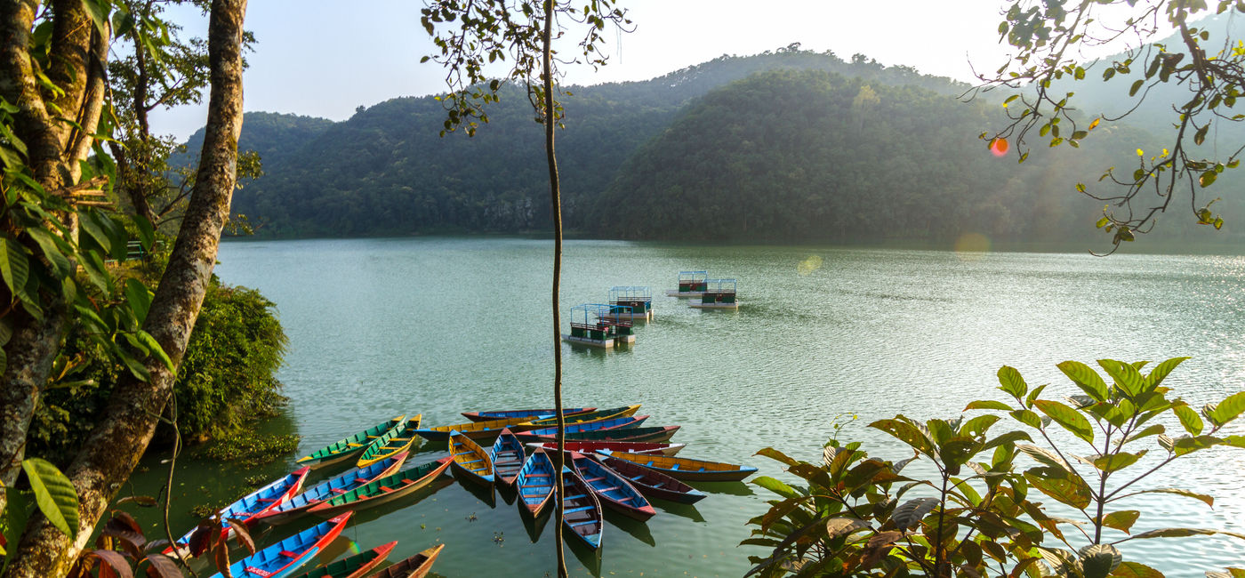 Image: PHOTO: Colorful canoe boats at sunrise on Phewa Lake in Pokhara, Nepal. (Jeff_Cagle / iStock / Getty Images Plus)