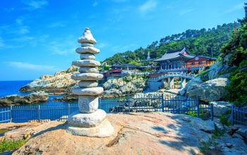 Haedong Yonggungsa Temple and Haeundae Sea in Busan, Korea (Photo via tawatchaiprakobkit / iStock / Getty Images Plus)
