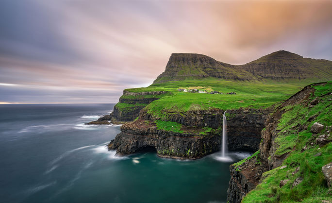 Gasadalur village and its waterfall, Faroe Islands, Denmark Gasadalur village and its iconic waterfall, Vagar, Faroe Islands, Denmark. Long exposure. (photo via miroslav_1 / iStock / Getty Images Plus)