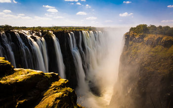 Victoria falls in Zimbabwe (photo via Tamer_Desouky / iStock / Getty Images Plus)