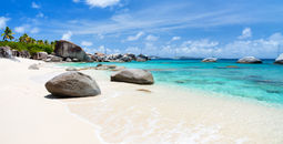 Beautiful tropical beach with white sand, turquoise ocean water and blue sky at Virgin Gorda, British Virgin Islands in Caribbean (Photo via shalamov / iStock / Getty Images Plus)
